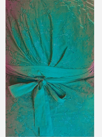 Close-up of a pink lace dress with a bow detail.