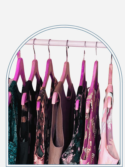 Clothing rack with various patterned shirts on a neutral background