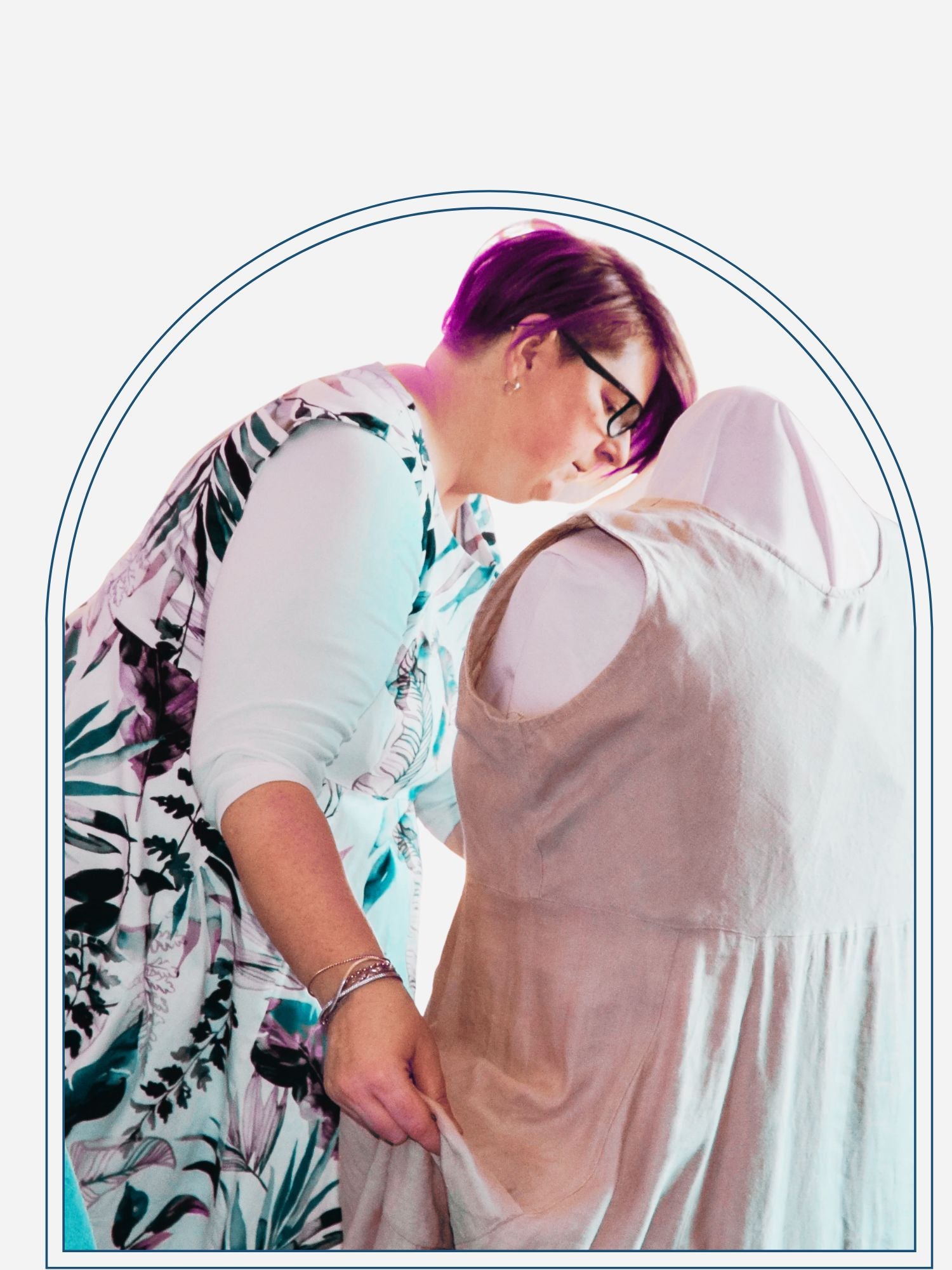 A person examining a dress on a mannequin, likely a consultation for custom pattern services.